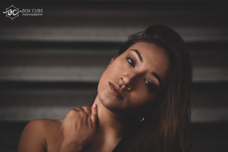 Model standing in front of rolling shutter in Downtown, Edmonton and posing for Box Cube Photograph - Portrait Photographer