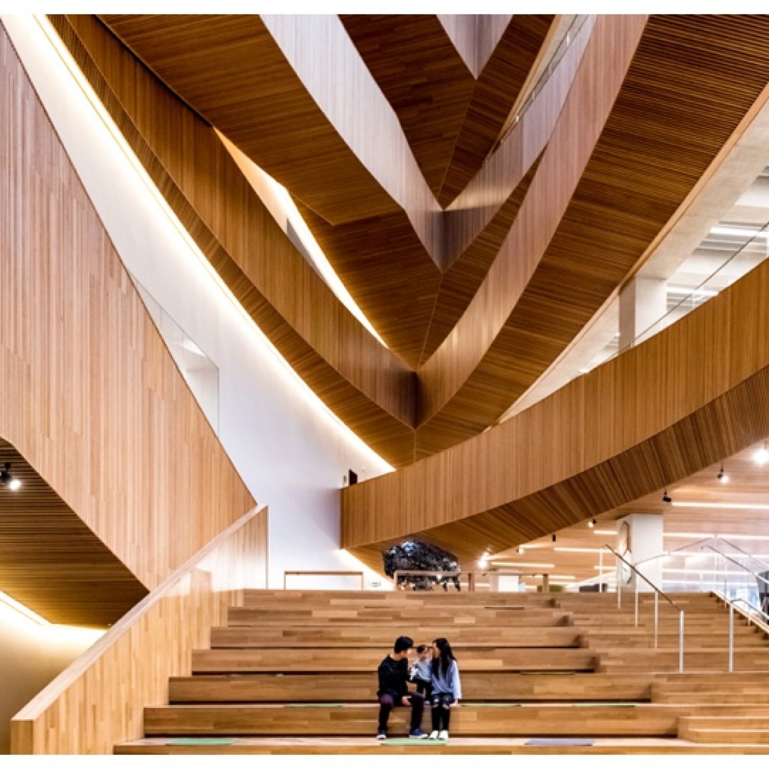 Editorial-style wedding photoshoot location down the iconic curved wooden staircase inside the Calgary Central Library 