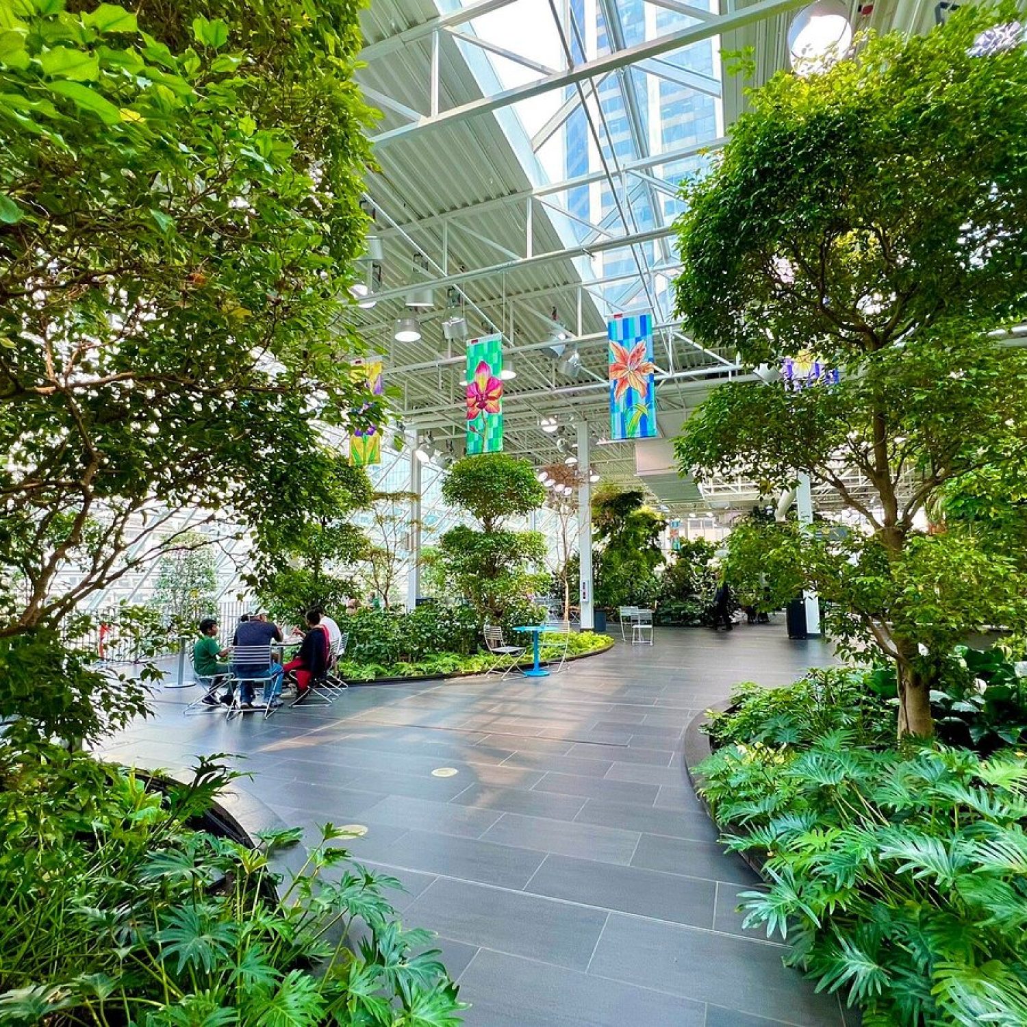 Lush indoor botanical setting at Devonian Gardens with tropical trees and skylights, providing a weather-proof Calgary photoshoot location.
